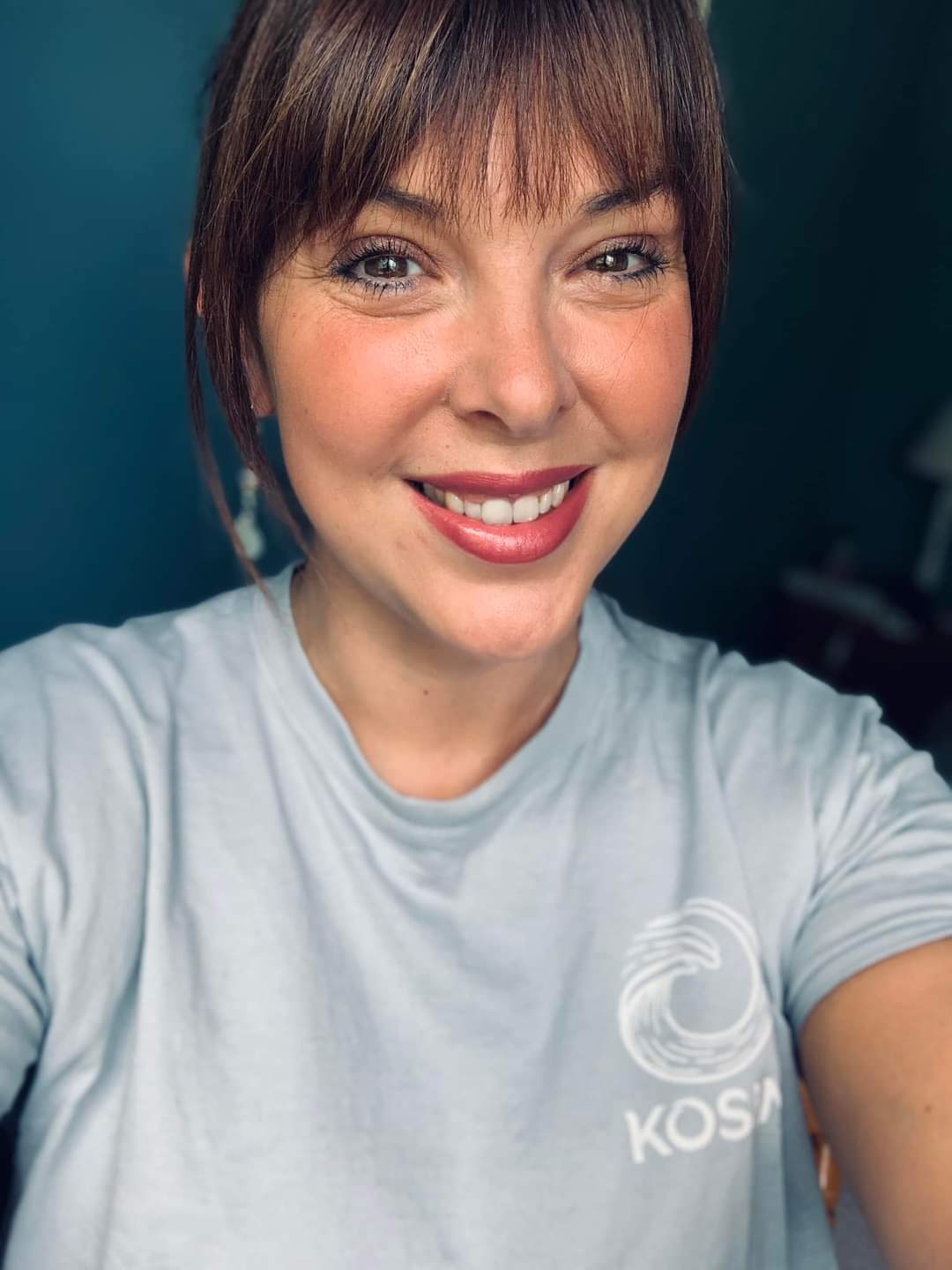 Catherine looks directly into the camera and smiles