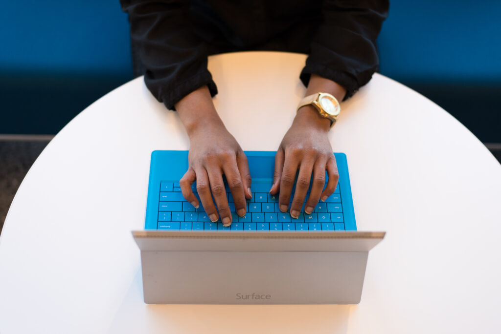 person writes on laptop