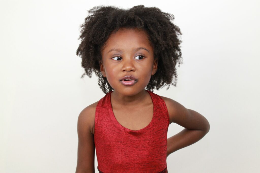 A young Black girl in a red top