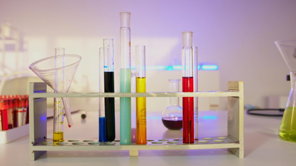Vibrant test tubes filled with liquids in a modern lab setting, showcasing scientific exploration.
