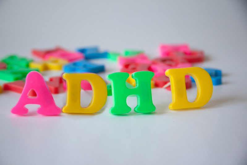 the letters ADHD spelled out in fridge magnet letters