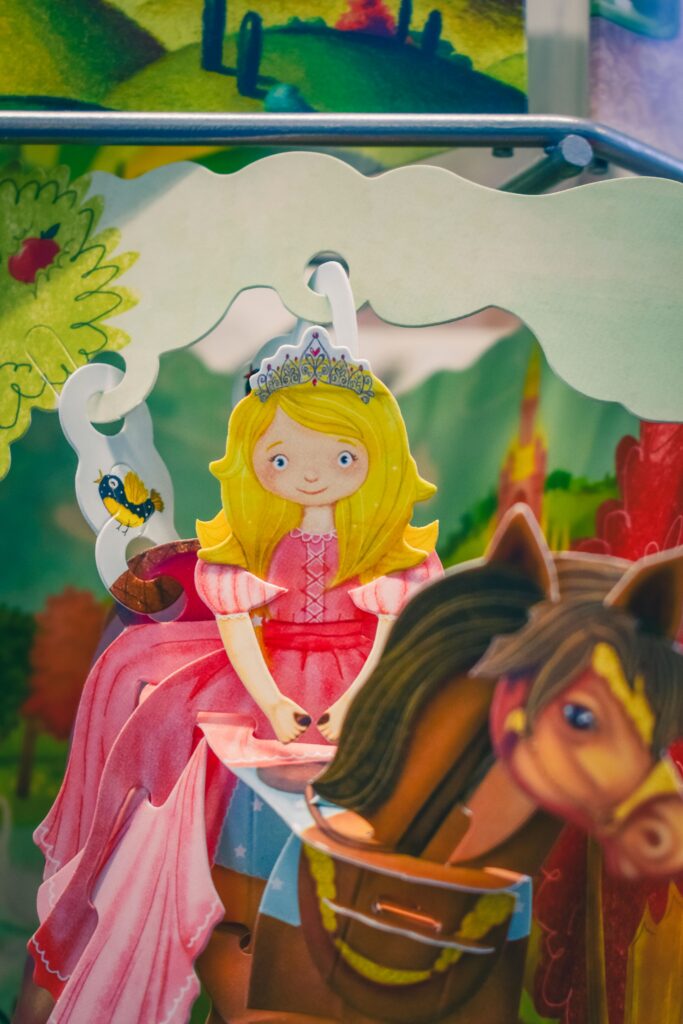 paper princess (white, blonde hair, femme) on a horse
