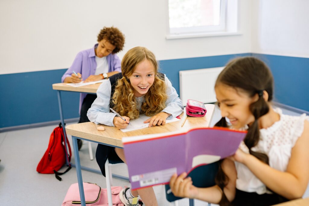 children in classroom share work